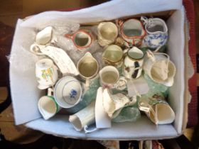A box containing a quantity of bone china and pottery miniature jugs of various form and maker
