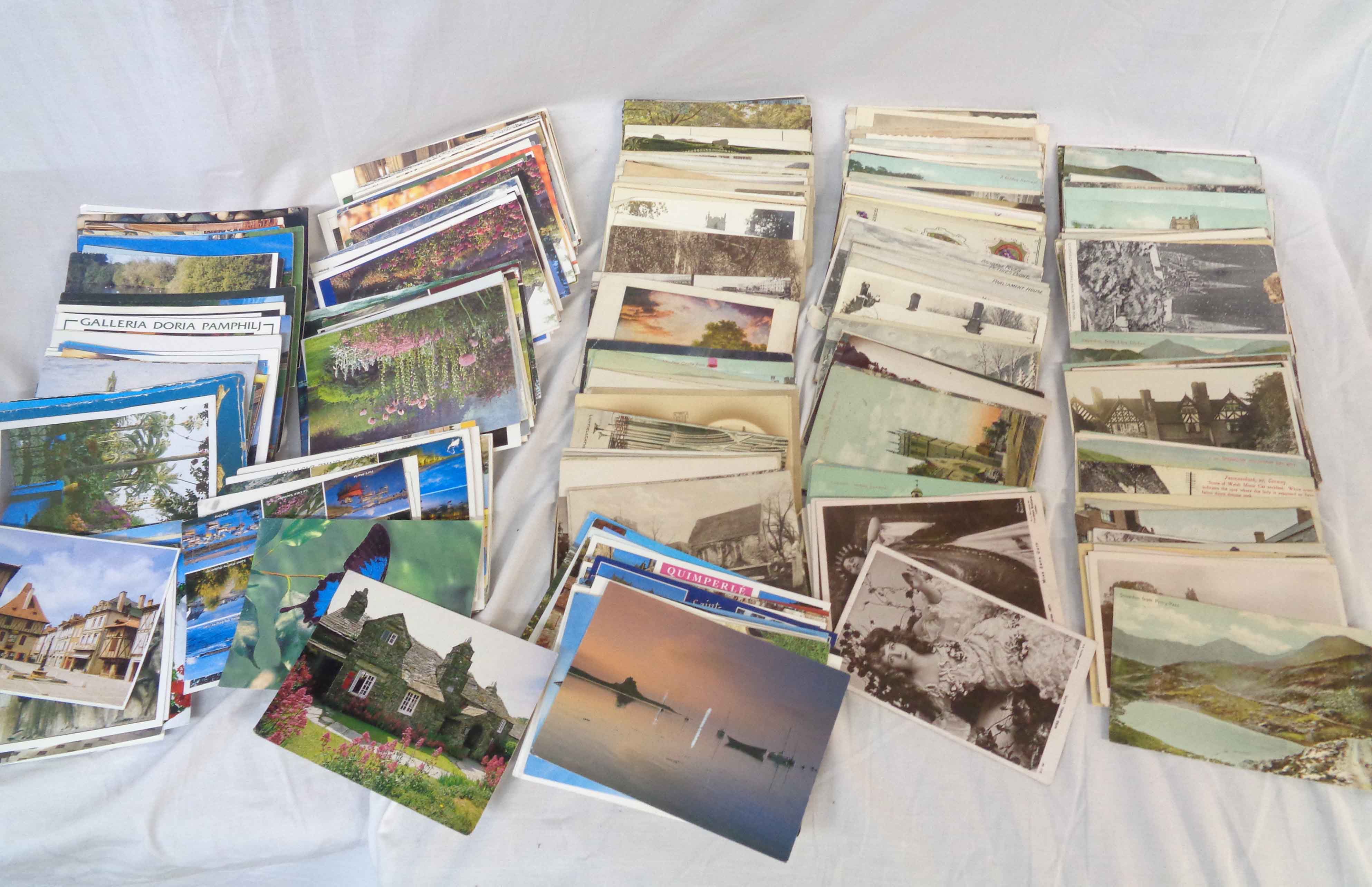 A box containing a collection of early 20th Century and later postcards including topographic, named