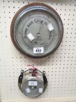 A vintage oak framed wall barometer with printed dial marked for W. Greenwood & Sons, with aneroid