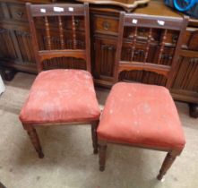 A pair of Edwardian mahogany spindle back standard chairs with upholstered seat panels