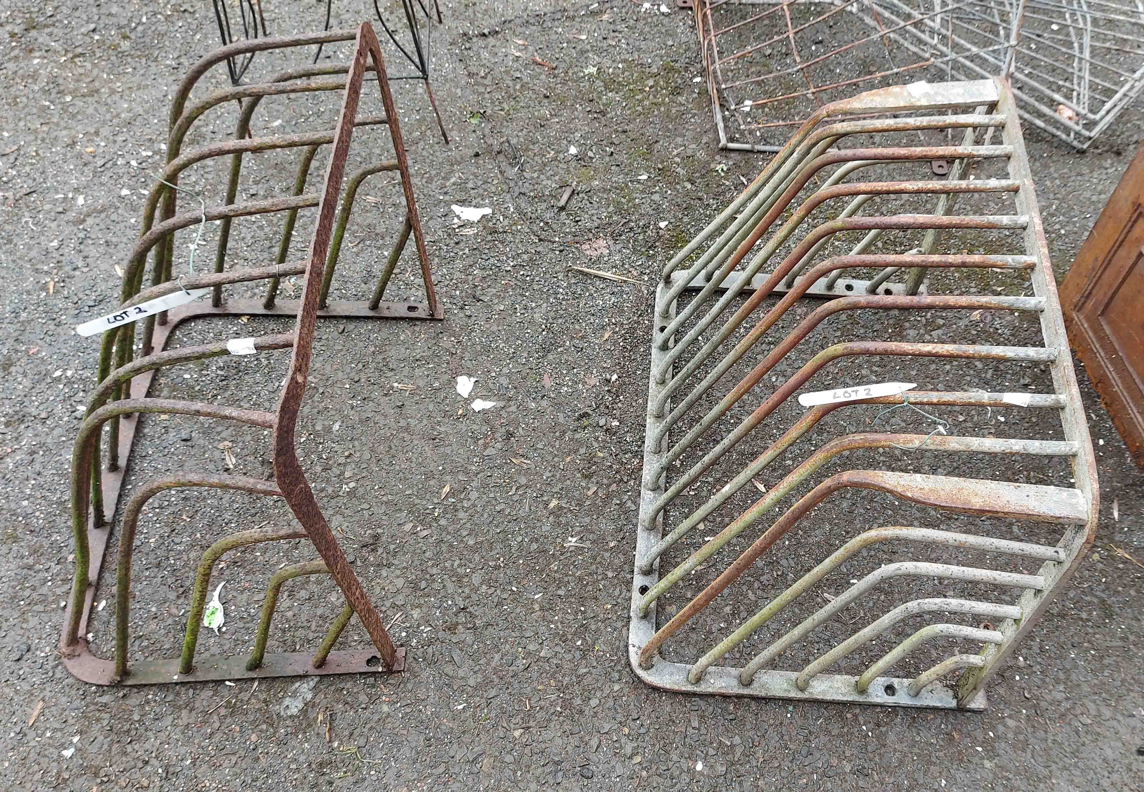 Two vintage metal hay racks