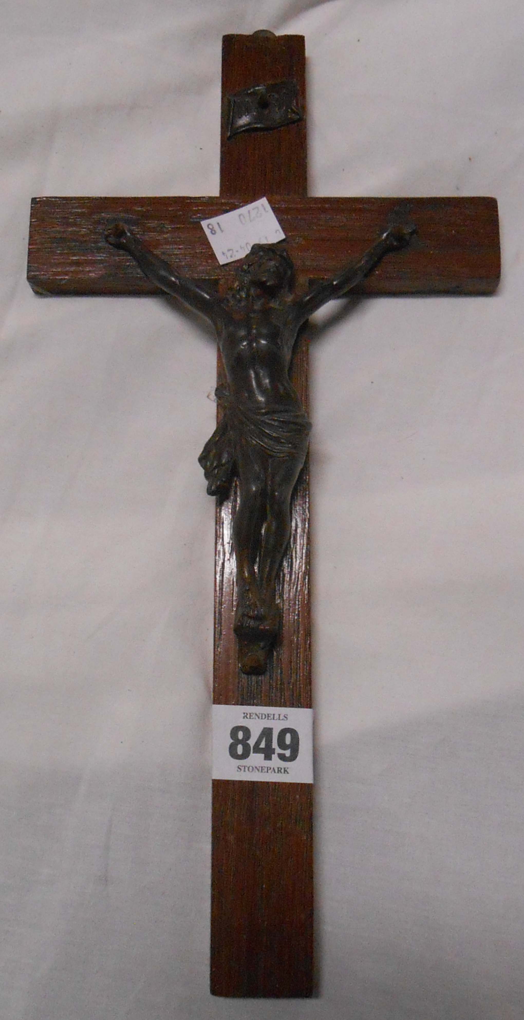 A wooden crucifix with spelter depiction of Jesus and an offertory box