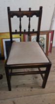 Three matching Ercol dark elm Gothic style standard dining chairs with upholstered drop-in seats