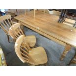 A 1.8m modern pine farmhouse style dining table with solid sectional top, set on turned legs -