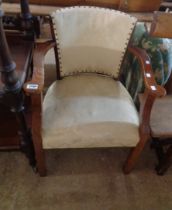 A 20th Century oak show frame elbow chair with tapestry upholstery and overstuffed seat, set on