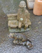 Two stone garden ornaments one depicting an otter, the other a man seated upon a bench