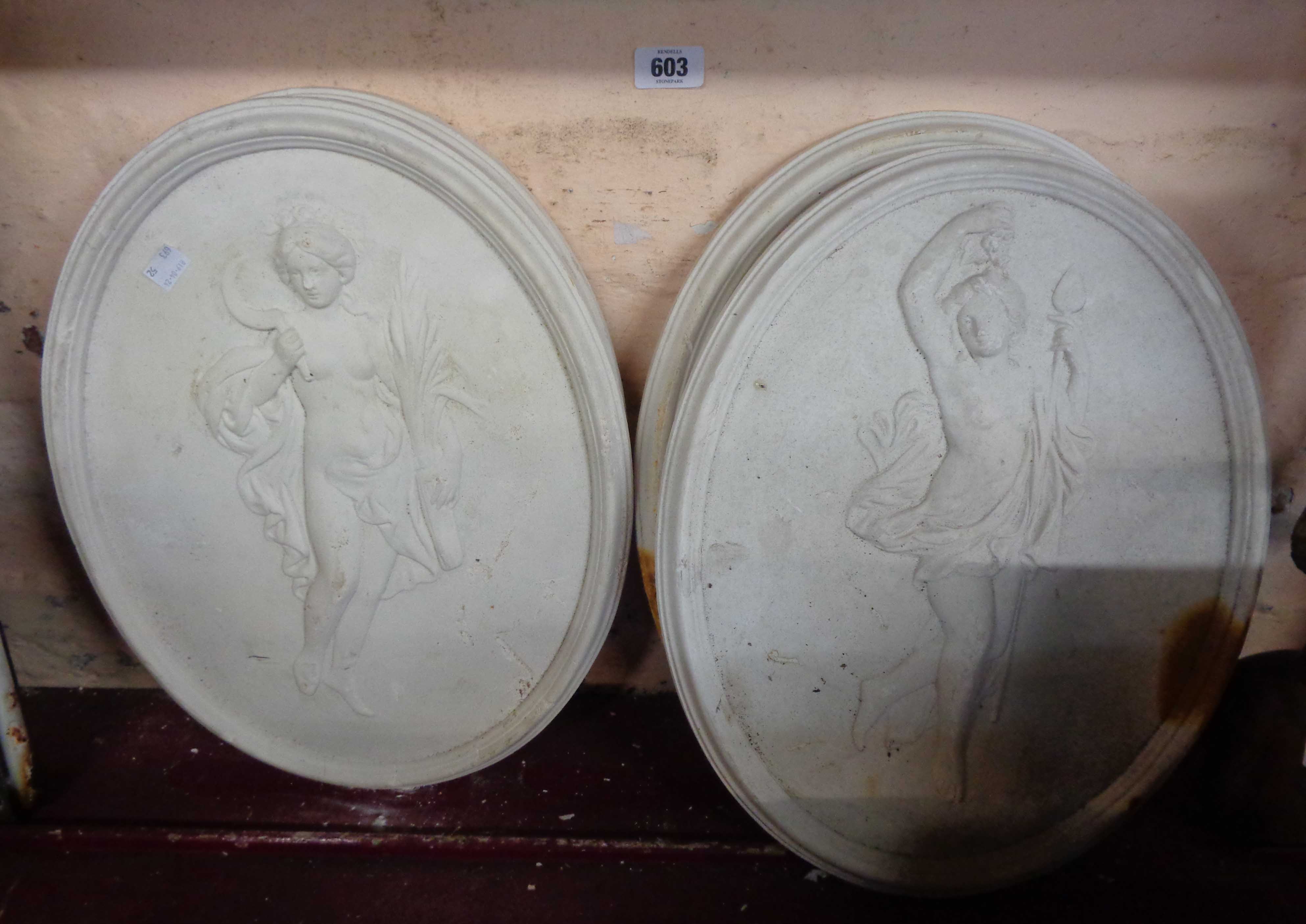 Four oval plaster plaques, depicting classical maidens