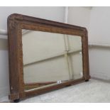 A 92cm late Victorian simulated rosewood and gilt framed overmantel mirror, set on pommel feet