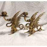 A pair of 19th Century cast brass candlesticks of gryphon form