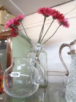A blown glass jug - sold with a glass jar with flowers