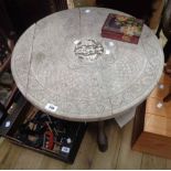 A 63cm diameter old Indian carved hardwood tabletop with central figural decoration, set on an