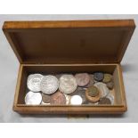 A decorative wooden box containing a small quantity of world coinage including US Dollar, US Half