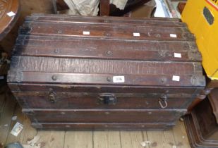 A 67cm antique dome-top travelling trunk with iron and wood bound weather coating and flanking