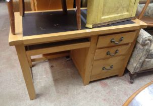 A 1.3m modern light oak single pedestal desk with inset writing surface and three graduated pedestal