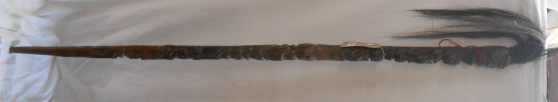 A large African tribal carved staff decorated with stacked human depictions