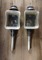 A pair of antique black painted metal candle lit carriage lamps - one glass panel a/f