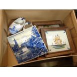 A small box containing three modern framed Dutch Delft tiles, two clogs and another unframed tile