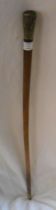 An old walking stick with decorative white metal embossed top