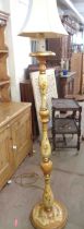 A vintage Italian painted wood standard lamp with all-over floral decoration to turned pillar, set