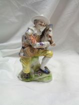 An antique Chelsea style porcelain figurine, depicting a man with a goat - gold anchor mark to