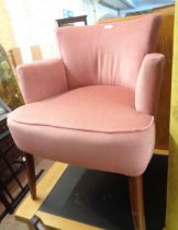 An early 20th Century boudoir elbow chair with pink velour upholstery, set on swept legs