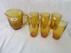 An amber moulded glass water set comprising jug and six tumblers
