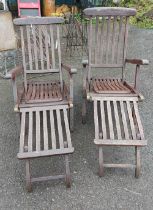 Two wooden garden lounger chairs