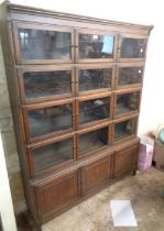 A 1.03m vintage oak five section modular bookcase comprising four glazed cupboard sections and