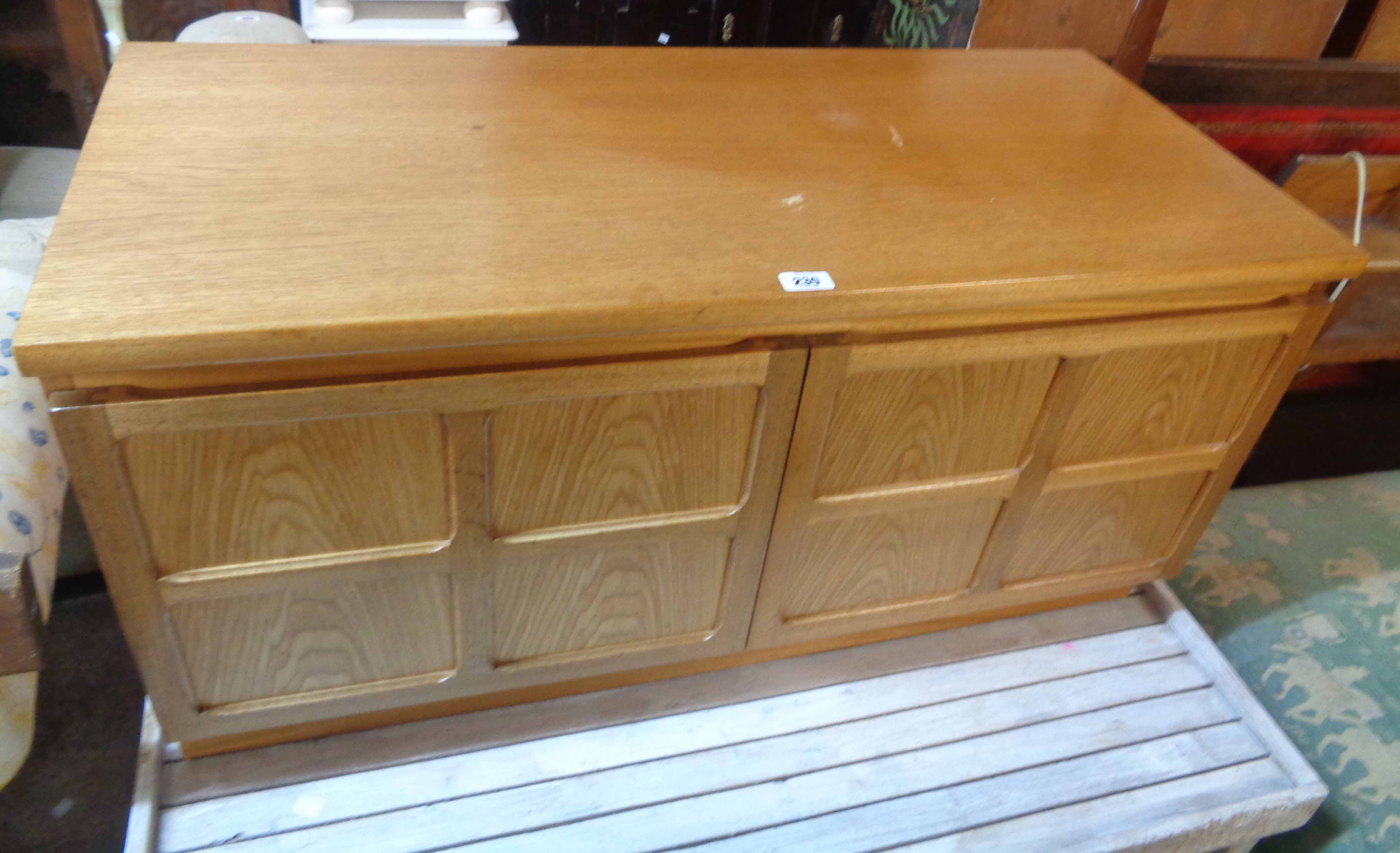 A 1.03m Nathan Furniture retro teak effect cupboard with shelves enclosed by a pair of panelled