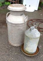 A vintage milk churn and chicken feeder