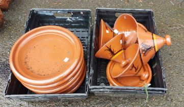 Two crates containing a quantity of Tagine cooking pots with lids and a quantity of Tagine bases