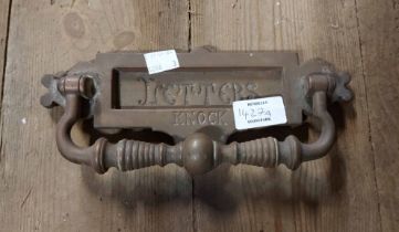 An antique brass letter box with door knocker