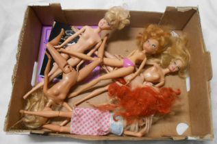 A box containing four Barbie fashion dolls, four commemorative Barbie postcards and a birthday