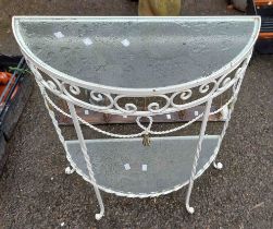 A semi circular glass and metal garden table