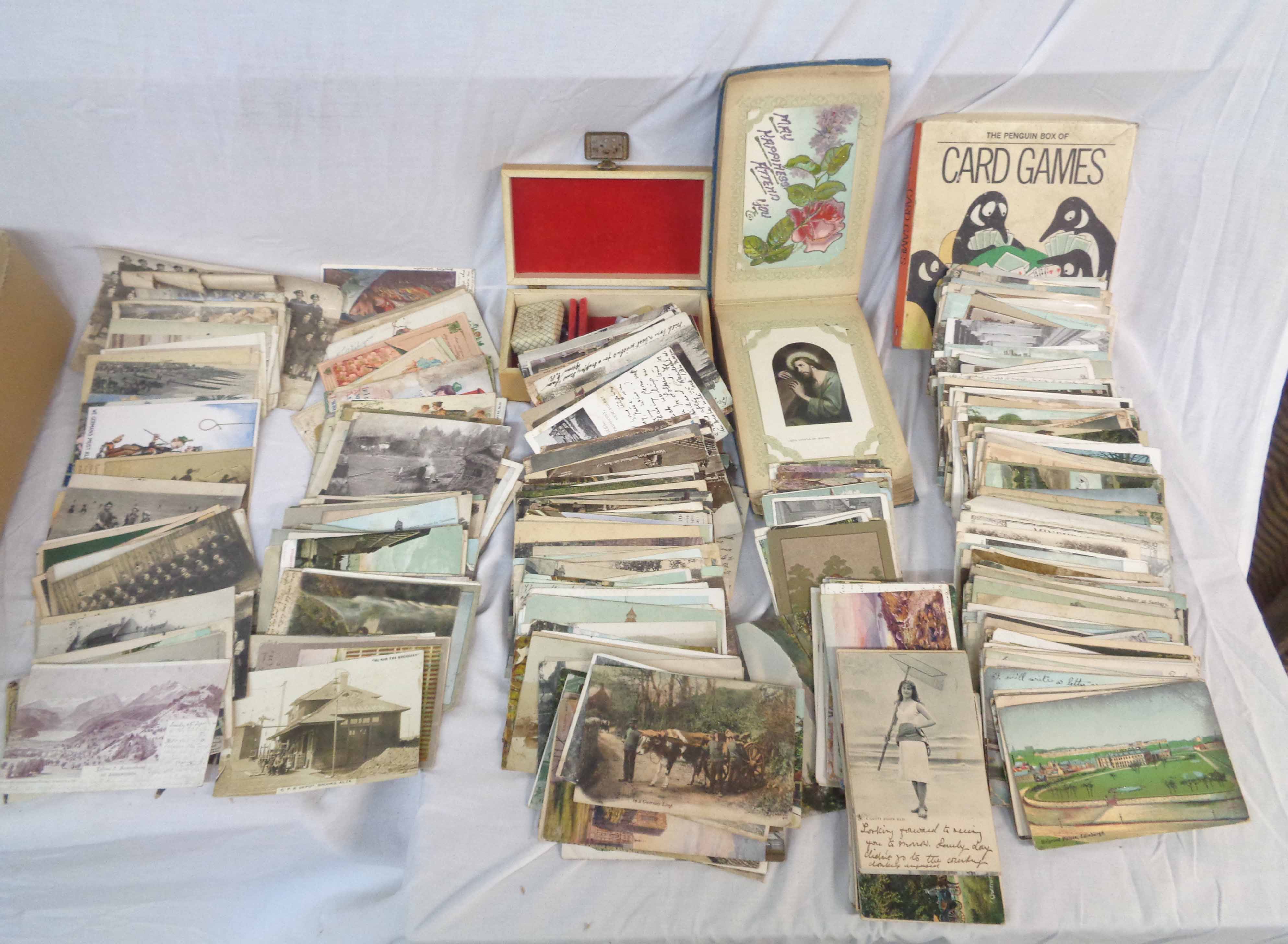 A box containing a collection of early 20th Century and other postcards including topographic, named