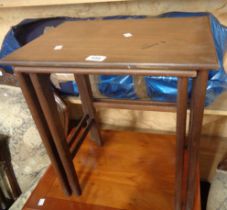 Two mid 20th Century teak nesting tea tables, set on moulded supports