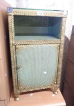 A vintage loom style bedside cabinet with glass top, recess and single door under