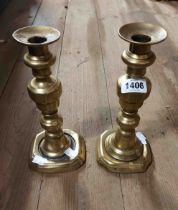A pair of early 19th Century cast brass candlesticks