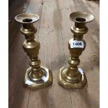 A pair of early 19th Century cast brass candlesticks