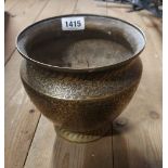 A brass pot with all around etched floral decoration