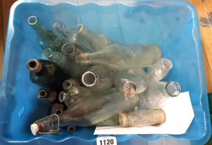 A crate containing a quantity of old glass bottles