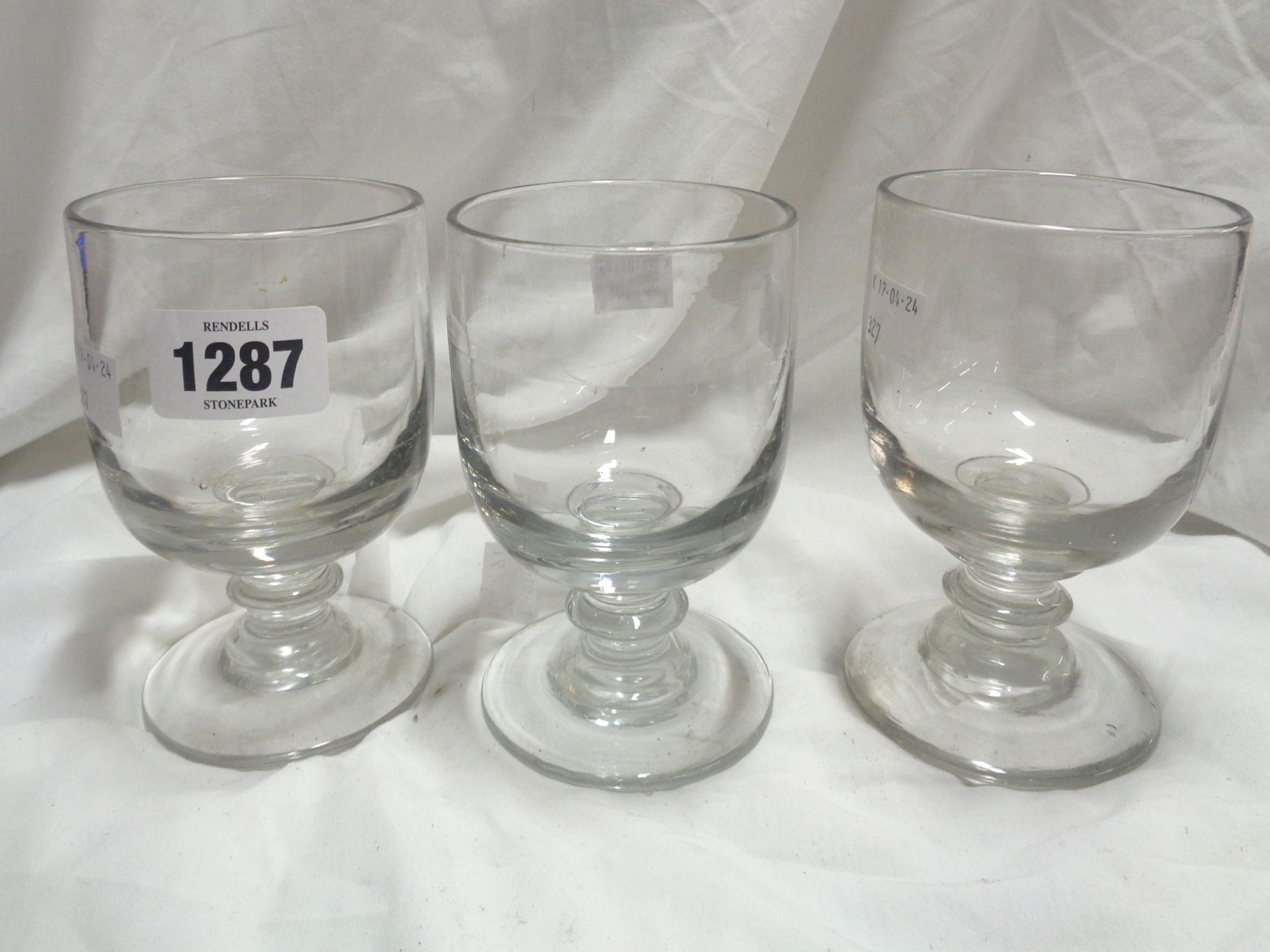 Three 19th Century glass rummers of squat goblet form, each with short bladed knopped stem