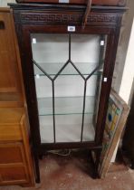 A 60cm early 20th Century mahogany display cabinet with glass shelves enclosed by a single