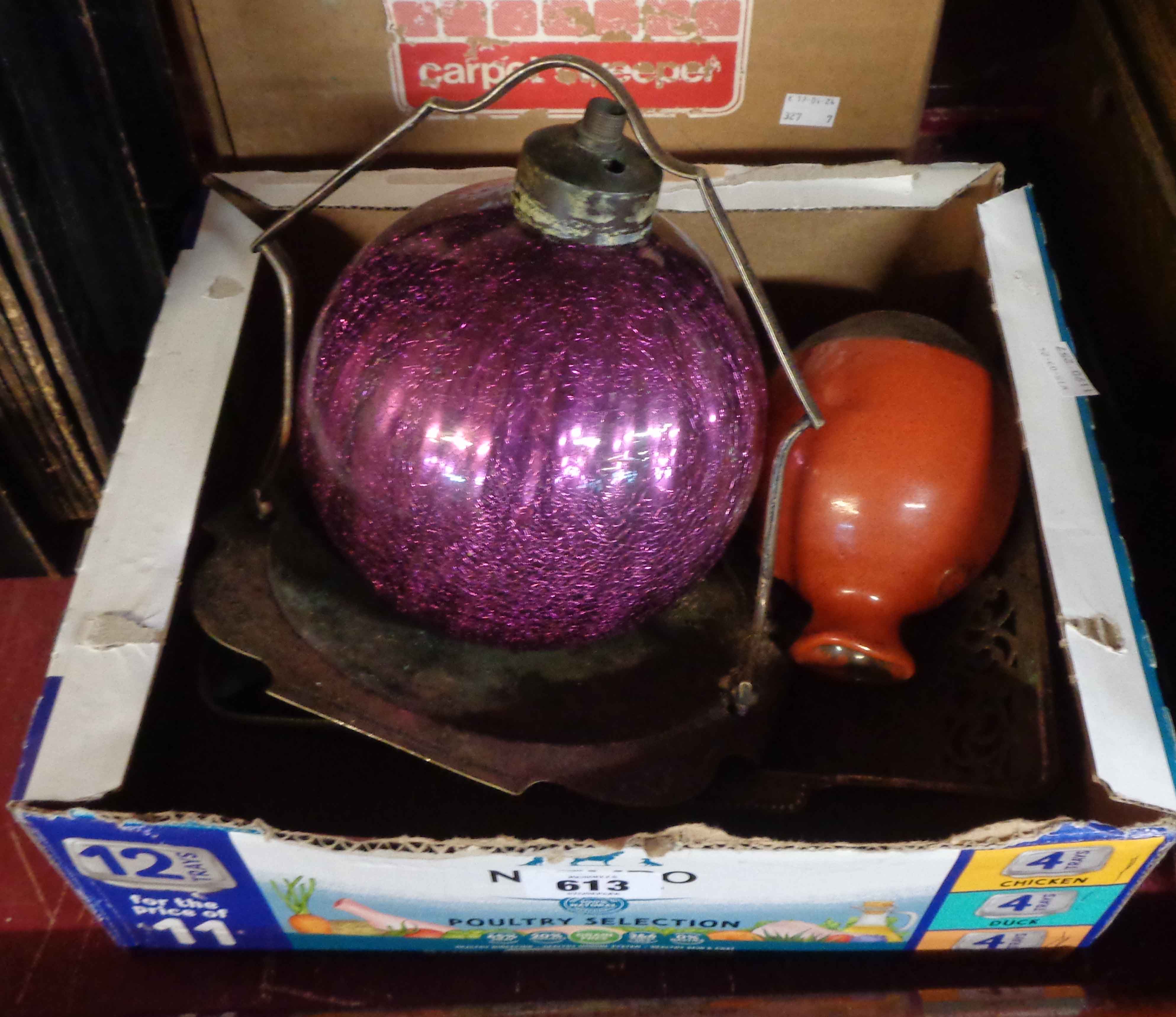 A box containing various items including a purple mercury crackle glass table lamp, small red