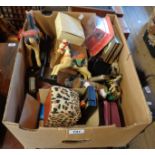 A box containing a quantity of assorted items including cameras, decorative rocking horses, etc.