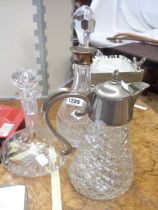 A vintage cut glass decanter with white metal collar - sold with another similar and a claret jug