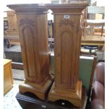 A pair of Keenpine narrow bedside cabinets, both with shelves enclosed by a carved door, set on