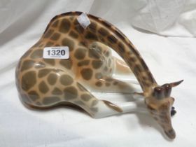 A USSR Lomonosov pottery figurine, depicting a recumbent giraffe