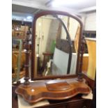 A Victorian mahogany serpentine front platform dressing table mirror with arched plate and lift-