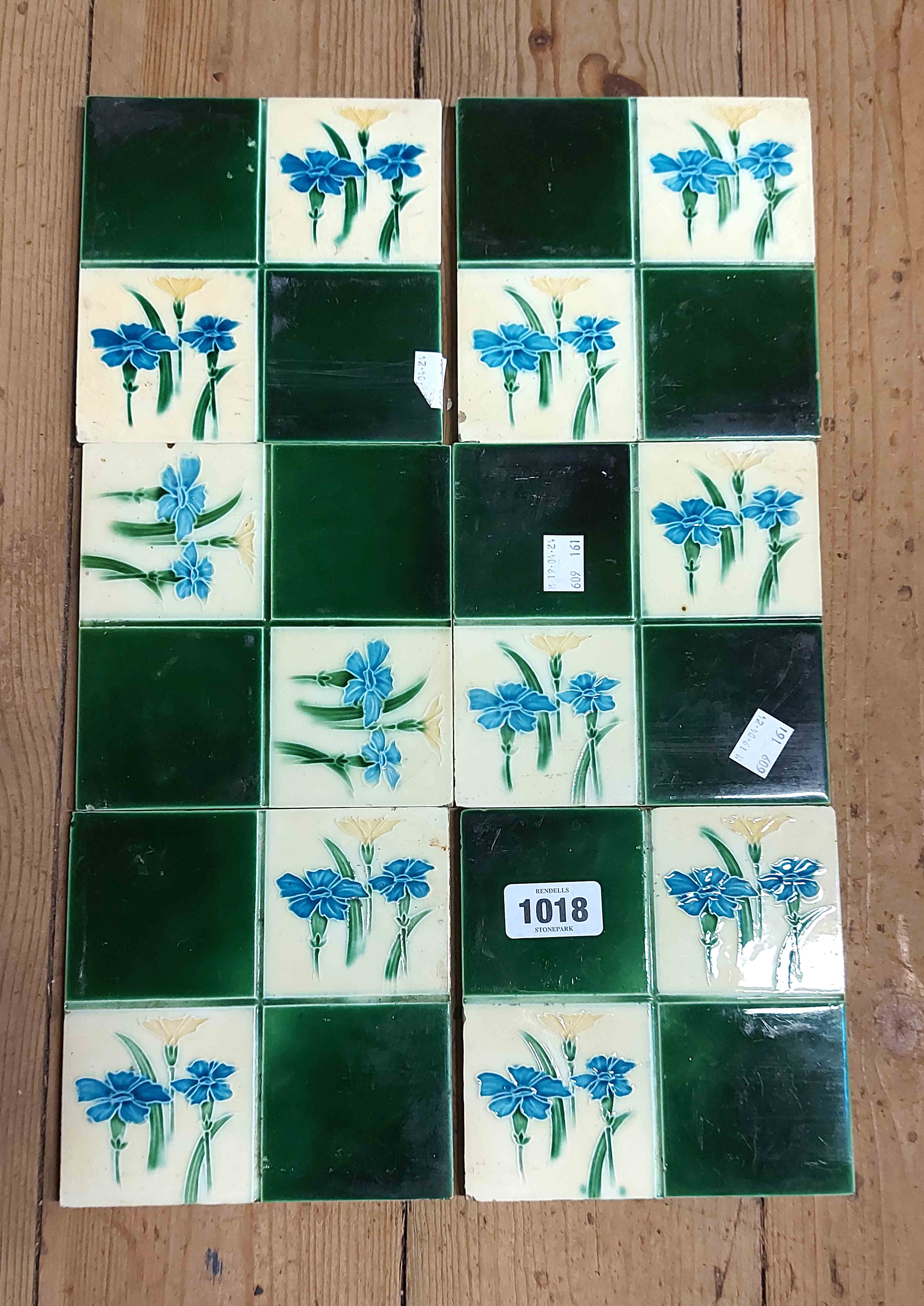 Six Victorian dust-pressed ceramic tiles, each decorated with floral motifs on a green and cream